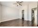 Bedroom features wood floors, a ceiling fan, and entrances to the walk-in closet and laundry room at 9314 Indian Corn Ct # 102, Las Vegas, NV 89178