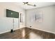 An empty bedroom with wood floors and a ceiling fan, leading to the Primary bath and walk-in closet at 9314 Indian Corn Ct # 102, Las Vegas, NV 89178