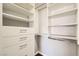 Walk in closet with built in white storage cabinets and drawers at 9314 Indian Corn Ct # 102, Las Vegas, NV 89178