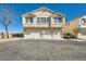 Attractive townhouse complex with three garage spaces, showcasing clean architecture and ample parking at 9314 Indian Corn Ct # 102, Las Vegas, NV 89178