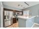 Modern kitchen featuring stainless steel appliances, sleek quartz countertops, and stylish dark cabinets at 9314 Indian Corn Ct # 102, Las Vegas, NV 89178