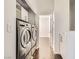 Laundry room features washer, dryer and overhead cabinets at 9314 Indian Corn Ct # 102, Las Vegas, NV 89178