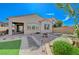 Backyard with a brick patio, small covered patio, and desert landscaping at 9940 Heather Moore Ave, Las Vegas, NV 89166