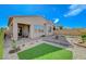 A spacious backyard with a paved patio, covered patio, and desert landscaping at 9940 Heather Moore Ave, Las Vegas, NV 89166