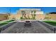 Landscaped backyard featuring stone pavers, desert plants, small trees and a cozy fire pit area at 9940 Heather Moore Ave, Las Vegas, NV 89166