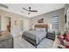 Bright bedroom features neutral decor, plantation shutters, and an ensuite bathroom at 9940 Heather Moore Ave, Las Vegas, NV 89166