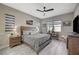 Comfortable bedroom with neutral tones, natural light, and modern ceiling fan at 9940 Heather Moore Ave, Las Vegas, NV 89166
