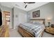 Bedroom featuring a rustic wooden bed frame, modern ceiling fan, and neutral-toned walls and carpet at 9940 Heather Moore Ave, Las Vegas, NV 89166