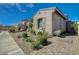 Landscaped home exterior showcasing a walkway, desert landscaping, and a neutral palette that exudes modern elegance at 9940 Heather Moore Ave, Las Vegas, NV 89166