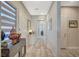 Hallway with tile flooring, decorative furniture, and neutral wall paint, leading to other rooms at 9940 Heather Moore Ave, Las Vegas, NV 89166