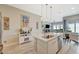 Open concept kitchen with island, stainless steel sink, and view of the living area at 9940 Heather Moore Ave, Las Vegas, NV 89166