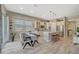 Eat-in kitchen features an island with bar seating, stainless appliances, and modern finishes at 9940 Heather Moore Ave, Las Vegas, NV 89166