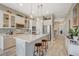 Modern white kitchen with stainless steel appliances, island seating, and pendant lighting at 9940 Heather Moore Ave, Las Vegas, NV 89166