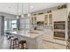 Bright kitchen features a large island, stainless steel appliances, and ample cabinet space at 9940 Heather Moore Ave, Las Vegas, NV 89166