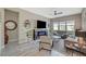 Inviting living room featuring neutral walls, a modern fireplace, and large windows that brighten the space at 9940 Heather Moore Ave, Las Vegas, NV 89166