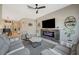 Inviting living room with a modern fireplace, comfortable seating, and stylish shelving at 9940 Heather Moore Ave, Las Vegas, NV 89166