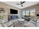 Cozy living room showcases a sleek electric fireplace, plush seating, and abundant natural light through large windows at 9940 Heather Moore Ave, Las Vegas, NV 89166
