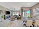 Bright living space with a dining area featuring tile flooring and a sliding glass door leading to outdoor space at 9940 Heather Moore Ave, Las Vegas, NV 89166
