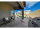 Covered patio featuring brick pavers, outdoor seating, a grill and desert landscaping perfect for relaxing and entertaining at 9940 Heather Moore Ave, Las Vegas, NV 89166