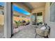 Covered patio featuring brick pavers, outdoor seating, a grill and desert landscaping perfect for relaxing and entertaining at 9940 Heather Moore Ave, Las Vegas, NV 89166