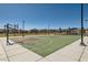 Outdoor community basketball court with ample space for players and spectators with green surfaces at 10239 Meandering Dell Ave, Las Vegas, NV 89166