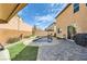 Private backyard oasis with a pool, patio, and lush artificial turf at 10316 Northern Hills Ave, Las Vegas, NV 89166