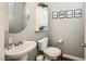 Cozy half bathroom featuring a pedestal sink, decorative mirror, and gray walls with white trim at 10316 Northern Hills Ave, Las Vegas, NV 89166
