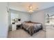 Comfortable bedroom with a ceiling fan, a vanity desk, and lots of natural light at 10316 Northern Hills Ave, Las Vegas, NV 89166