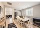 Bright dining room with a white table, seating for six, and tiled floors that flow into adjacent living spaces at 10316 Northern Hills Ave, Las Vegas, NV 89166