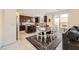 Open-concept kitchen and dining area featuring dark wood cabinets and a center island, perfect for entertaining at 10316 Northern Hills Ave, Las Vegas, NV 89166