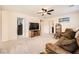 Cozy living room with plush sofa, ceiling fan, and neutral color palette at 10316 Northern Hills Ave, Las Vegas, NV 89166