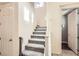 Carpeted staircase with white banister leading to the upper level, with access to the garage and other rooms at 10316 Northern Hills Ave, Las Vegas, NV 89166