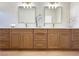 Bathroom featuring double sinks with quartz countertop and wood cabinets at 10412 Button Willow Dr, Las Vegas, NV 89134