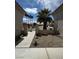 Welcoming front entrance features desert landscaping and a clear view of the neighborhood street with palm trees at 10412 Button Willow Dr, Las Vegas, NV 89134