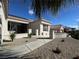 Attractive single-story home with desert landscaping, tile roof, and walkway to the front door creates curb appeal at 10412 Button Willow Dr, Las Vegas, NV 89134