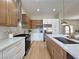 Modern kitchen featuring stainless steel appliances, two-tone cabinetry, and a spacious center island at 10412 Button Willow Dr, Las Vegas, NV 89134