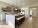 A modern kitchen featuring an island with bar stool seating, stainless appliances and stylish pendant lights at 10412 Button Willow Dr, Las Vegas, NV 89134