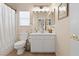 Well-lit bathroom features a single sink vanity and a shower-tub combo with neutral tones at 10638 La Spezia Way, Las Vegas, NV 89141