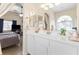 Bright bathroom features a double sink vanity, large mirror, and soaking tub at 10638 La Spezia Way, Las Vegas, NV 89141