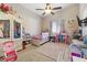 Bright bedroom features fun decorations, ceiling fan and large window at 10638 La Spezia Way, Las Vegas, NV 89141