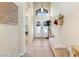 Inviting entryway features double doors, tiled flooring, a comfortable bench and decor at 10638 La Spezia Way, Las Vegas, NV 89141