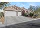 Charming home with a three-car garage, desert landscaping, and a welcoming entrance at 10638 La Spezia Way, Las Vegas, NV 89141