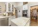 Kitchen island with white cabinets, marble countertops, and stainless steel appliances at 10638 La Spezia Way, Las Vegas, NV 89141