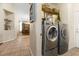 Convenient laundry area showcases modern washer and dryer units near a dining area at 10638 La Spezia Way, Las Vegas, NV 89141