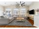 Bright living room with high ceilings, hardwood floors, and large windows providing ample natural light and comfort at 10638 La Spezia Way, Las Vegas, NV 89141