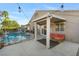 Relaxing covered patio area offers view of the pool and backyard, great for entertaining at 10638 La Spezia Way, Las Vegas, NV 89141