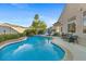 Sparkling blue pool with an attached spa and landscaped backyard for relaxation and enjoyment at 10638 La Spezia Way, Las Vegas, NV 89141