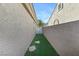 Functional side yard with artificial turf offers a low-maintenance outdoor space at 10638 La Spezia Way, Las Vegas, NV 89141