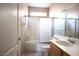 Bathroom featuring a shower-tub combo, a single sink vanity, and neutral tile flooring at 10657 Blue Nile Ct, Las Vegas, NV 89144