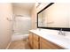 Bathroom featuring a double sink vanity, framed mirror, and shower with glass door at 10657 Blue Nile Ct, Las Vegas, NV 89144